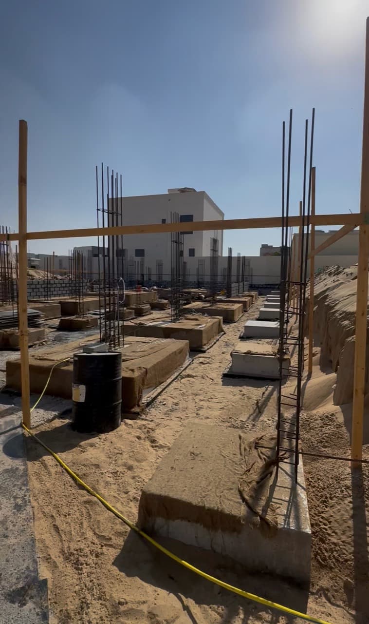 Owner-supplied site preparation photograph with column starters and foundations